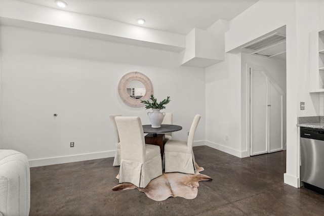 dining space with visible vents, baseboards, and finished concrete floors