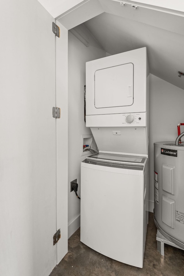 clothes washing area featuring water heater, laundry area, and stacked washer / dryer