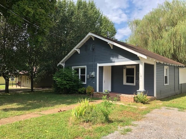 view of front of property with a front yard and covered porch