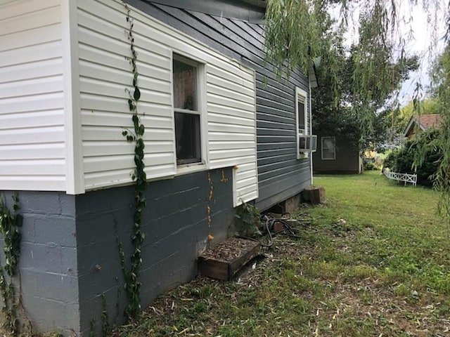 view of side of home with a lawn