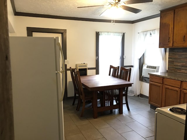 dining room with a textured ceiling, light tile patterned flooring, a ceiling fan, and crown molding