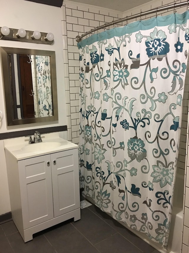 full bathroom featuring tile patterned flooring, vanity, and shower / bath combo with shower curtain