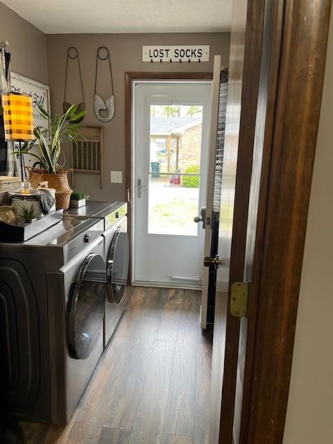 laundry room with washer and dryer, laundry area, and wood finished floors