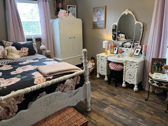 bedroom featuring dark wood-style flooring