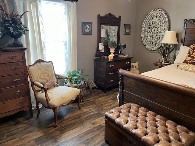 bedroom with dark wood finished floors