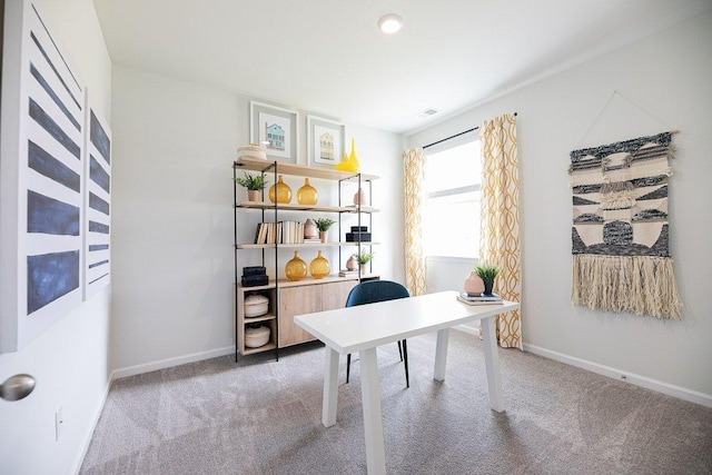 carpeted home office featuring baseboards