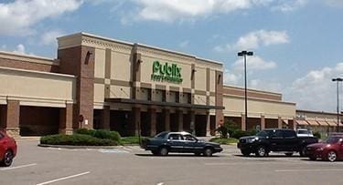 view of building exterior with uncovered parking