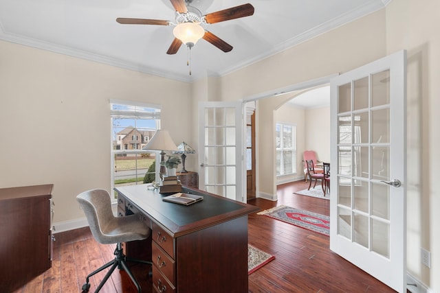 home office featuring crown molding, baseboards, french doors, arched walkways, and dark wood-style flooring