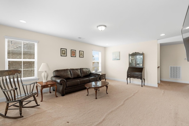 carpeted living area with recessed lighting, baseboards, and visible vents