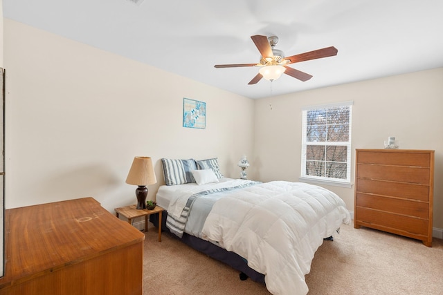 bedroom featuring a ceiling fan and light colored carpet