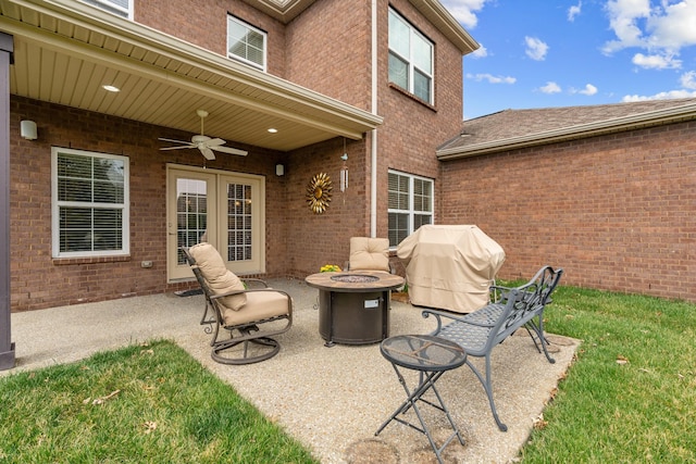 view of patio featuring ceiling fan, a fire pit, french doors, and a grill