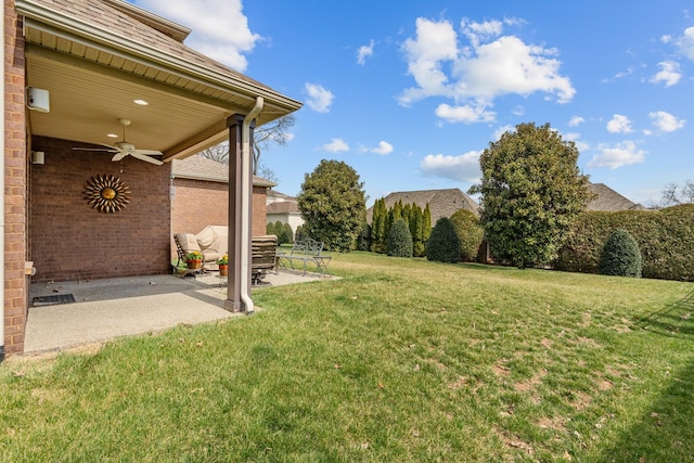 view of yard with a patio and ceiling fan