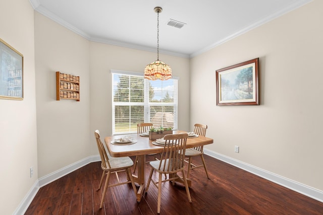 dining space featuring visible vents, baseboards, dark wood-type flooring, and crown molding