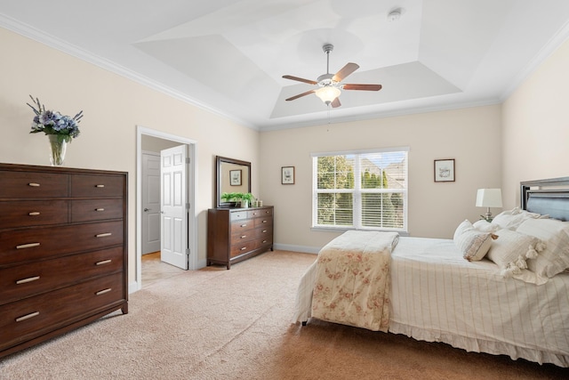 bedroom featuring a tray ceiling, crown molding, baseboards, and light carpet