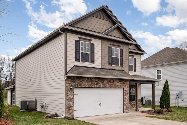 view of front of house featuring central air condition unit, a garage, concrete driveway, and a shingled roof