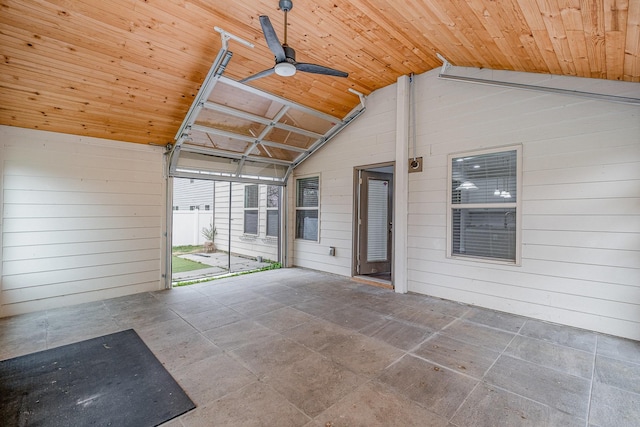 unfurnished sunroom with ceiling fan, wooden ceiling, and vaulted ceiling