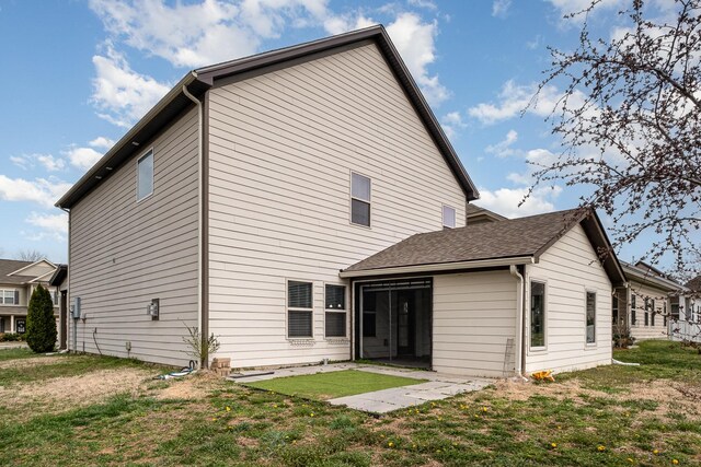 back of house with a lawn