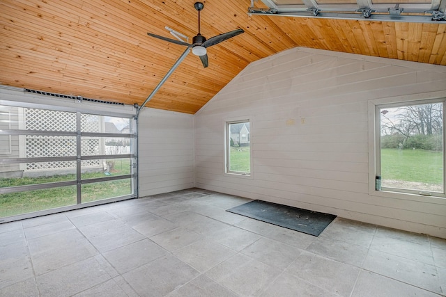 unfurnished sunroom featuring wood ceiling, a ceiling fan, and vaulted ceiling