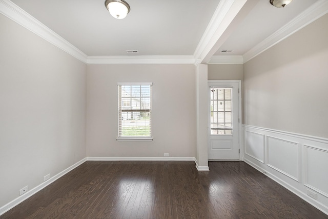 interior space with a wainscoted wall, wood finished floors, visible vents, and ornamental molding