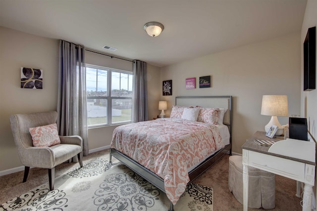 carpeted bedroom with visible vents and baseboards