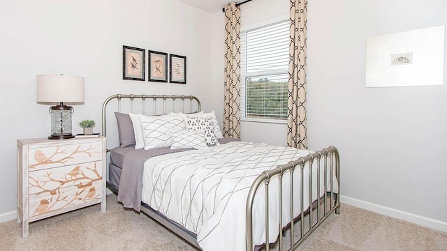 bedroom with baseboards and carpet