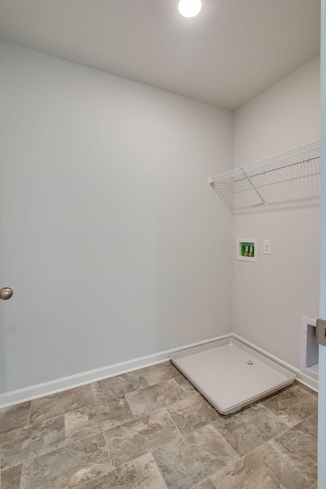 laundry area with stone finish flooring, baseboards, washer hookup, and laundry area