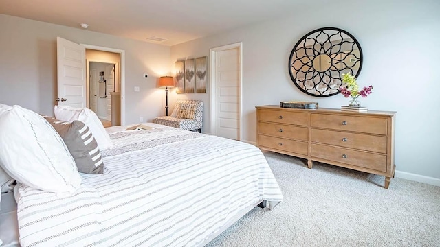 bedroom featuring light carpet and baseboards