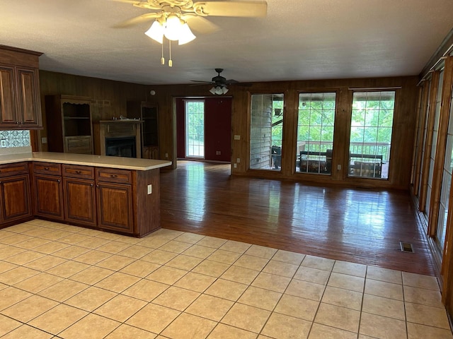 kitchen with ceiling fan, visible vents, open floor plan, and light countertops