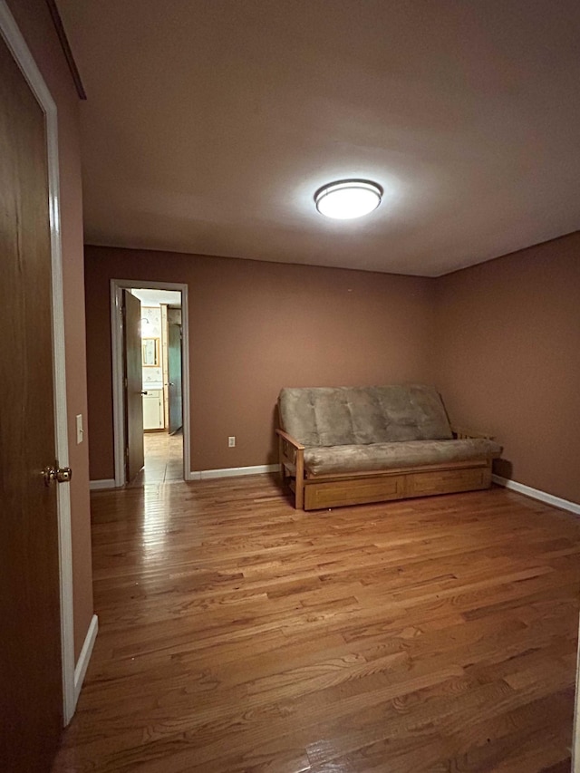 living area featuring wood finished floors and baseboards