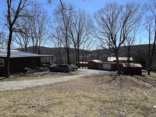 view of yard with driveway and a garage