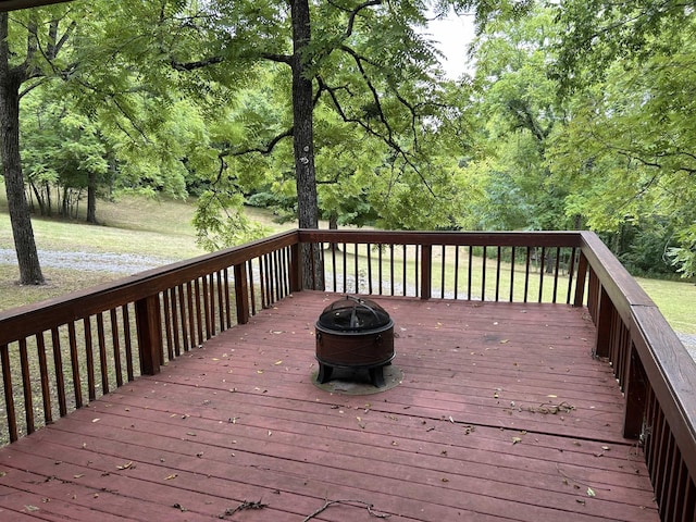 wooden terrace featuring a fire pit