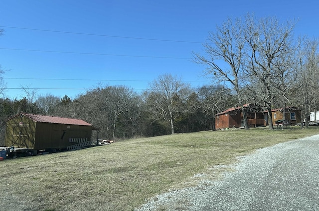 view of yard with a storage unit and an outbuilding