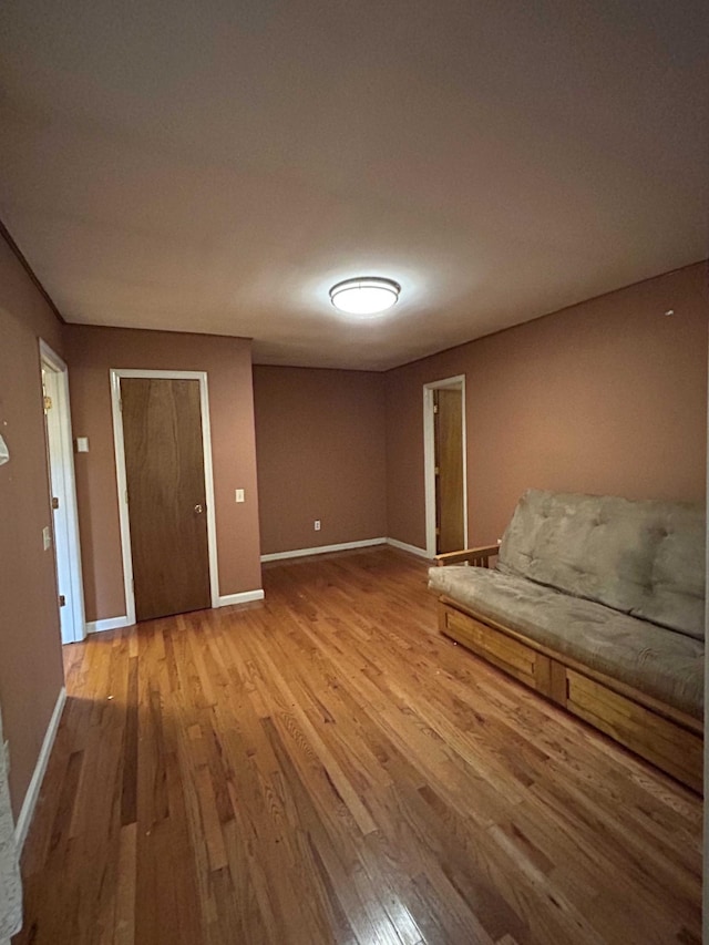 unfurnished bedroom featuring baseboards and wood finished floors