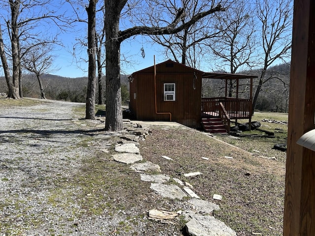 exterior space with an outbuilding and a wooden deck