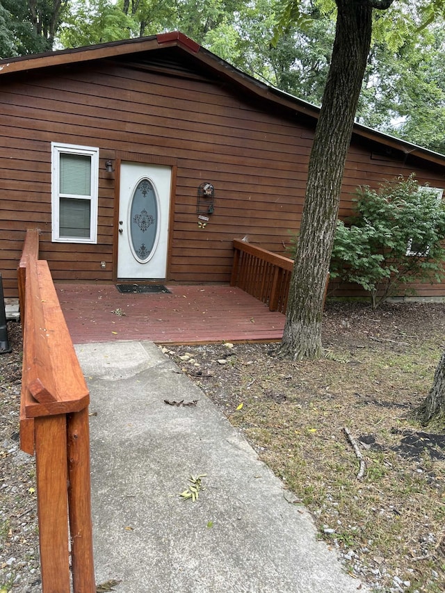 entrance to property with a wooden deck