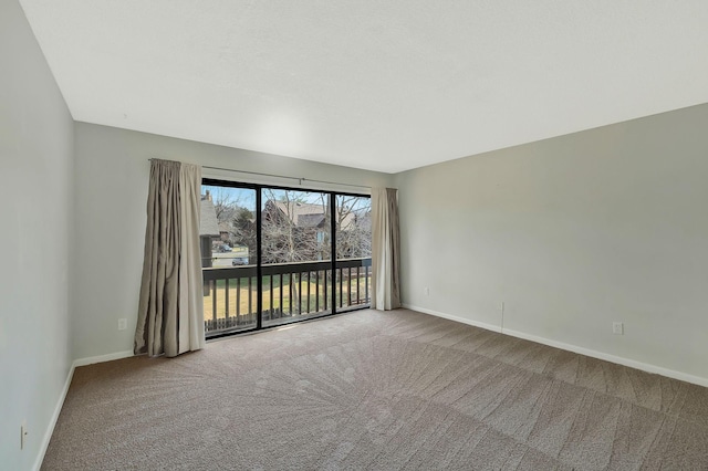 carpeted empty room with baseboards