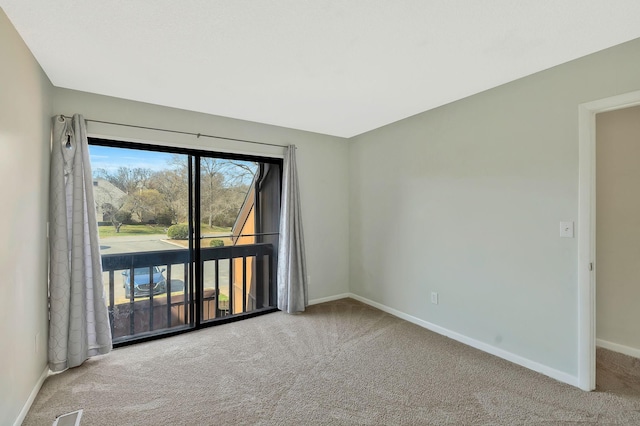 unfurnished room featuring carpet flooring and baseboards