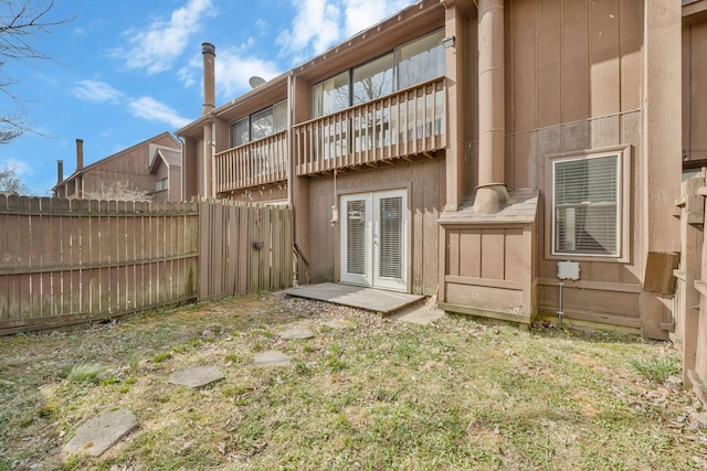 back of house featuring french doors and fence