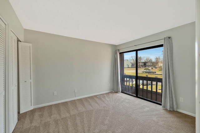 unfurnished bedroom featuring visible vents, baseboards, carpet, and access to outside