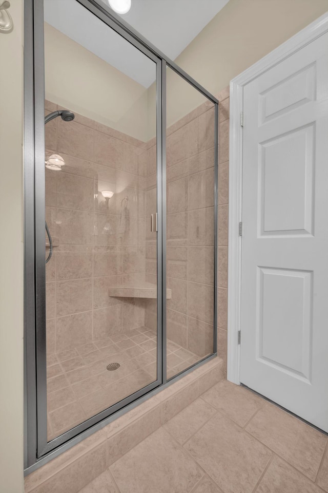 full bath featuring tile patterned floors and a stall shower