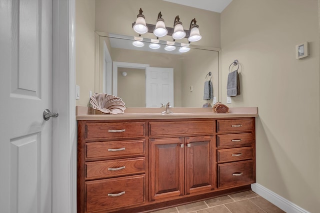 bathroom with vanity, tile patterned floors, and baseboards