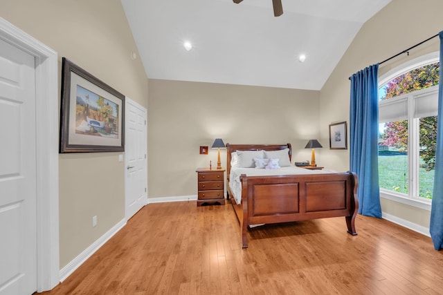 bedroom with lofted ceiling, light wood-style flooring, baseboards, and ceiling fan