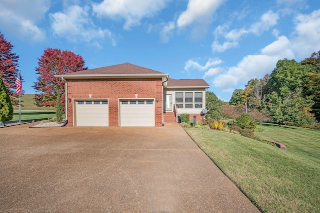 view of front facade featuring a garage, driveway, brick siding, and a front lawn