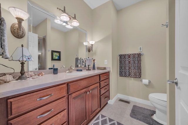 bathroom with vanity, baseboards, visible vents, a stall shower, and toilet