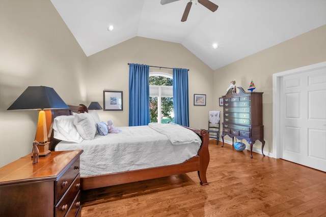 bedroom featuring vaulted ceiling, wood finished floors, baseboards, and ceiling fan