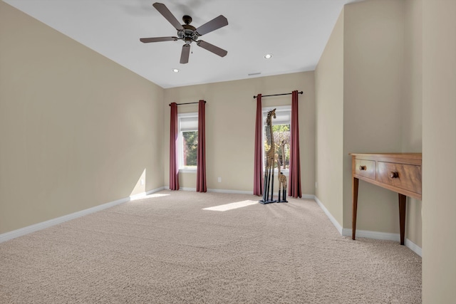 carpeted spare room featuring recessed lighting, baseboards, and a ceiling fan