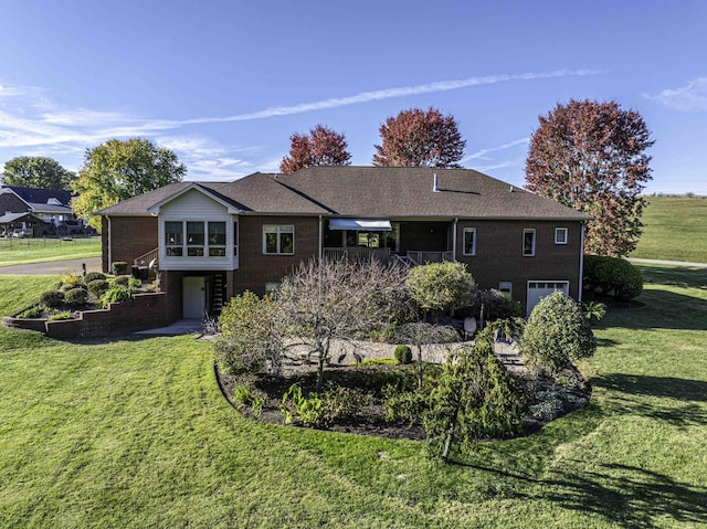 back of property featuring stairs, a yard, brick siding, and an attached garage