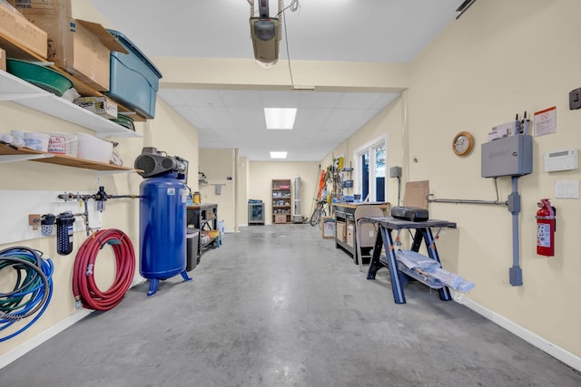 garage featuring a garage door opener and baseboards