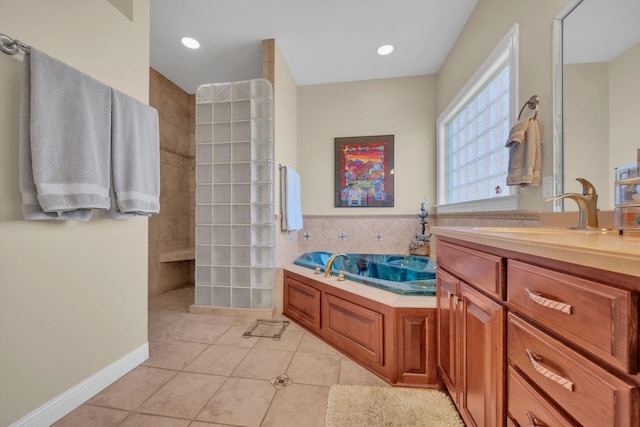 bathroom featuring tile patterned flooring, a walk in shower, tile walls, a bath, and vanity