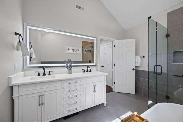 bathroom with a shower stall, visible vents, lofted ceiling, and a sink